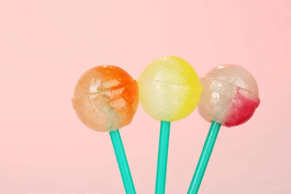 Stock image Bright and delicious lollipops on pink background close-up