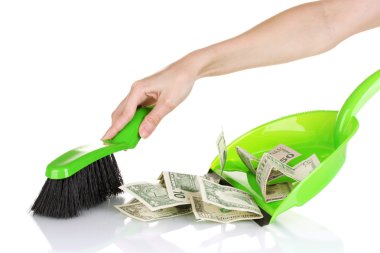 Sweeps money in the shovel on white background close-up clipart