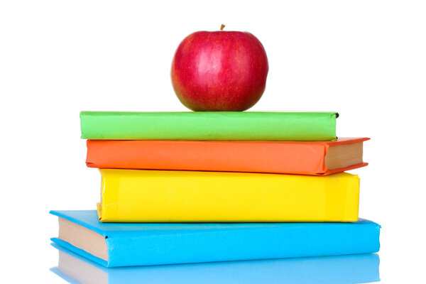 Composition of schoolbooks and an apple isolated on white