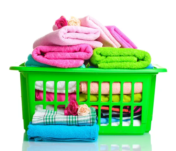 Towels in green plastic basket isolated on white Stock Picture