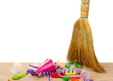 Broom sweep the trash after a party on white background close-up clipart