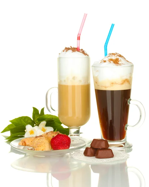 Glasses of coffee cocktail with sweets and flower isolated on white