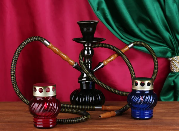 Hookah on a wooden table on a background of curtain close-up — Stock Photo, Image
