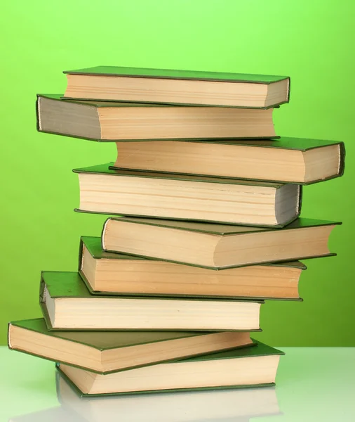 Tower of books on green background — Stock Photo, Image