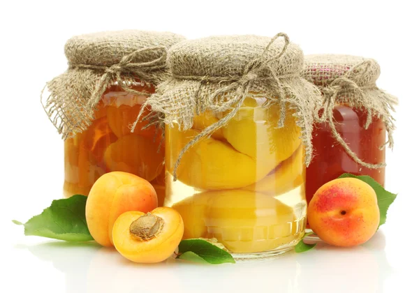 Canned apricots and jam in a jars with sweet apricots isolated on white — Stock Photo, Image