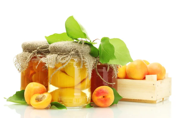 Canned apricots and jam in a jars with sweet apricots isolated on white — Stock Photo, Image