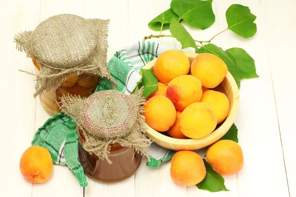 仁用杏、 在罐果酱罐头、 白色的木桌上的碗里成熟杏 — 图库照片