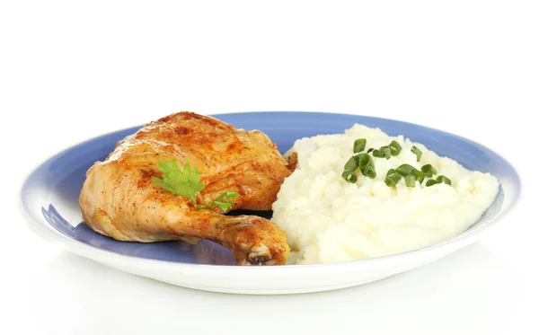 Roasted chicken leg with mashed potato in the plate isolated on white close-up Stock Photo