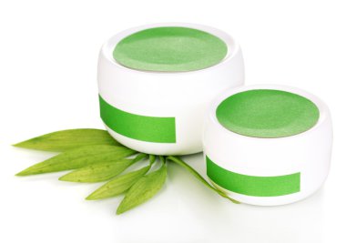 Jars of cream with green leaves isolated on white clipart