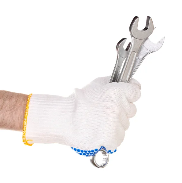 Ключи в руке с защитной перчаткой изолированы на белом — стоковое фото