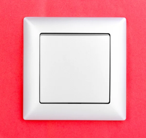 Сучасний вимикач світла на червоному тлі — стокове фото