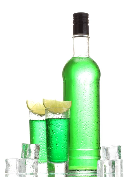 Bottle and glasses of absinthe with lime and ice isolated on white — Stock Photo, Image