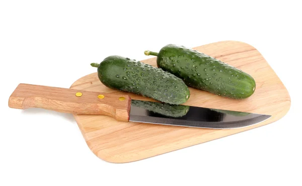 Fresh cucumbers and knife on wooden board isolated on white — Stock Photo, Image