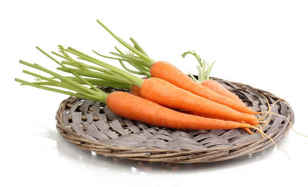 Zanahorias en alfombra trenzada aislada en blanco — Foto de Stock