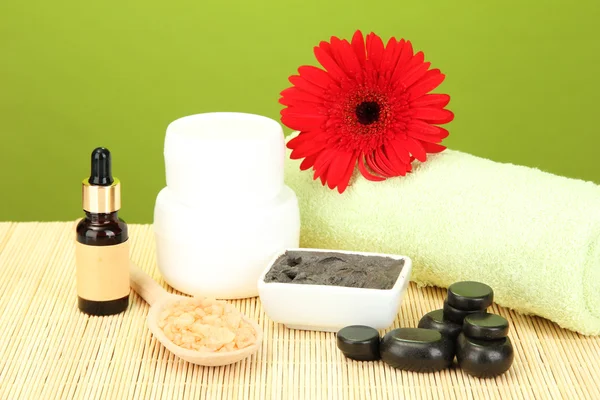 Kosmetiska lera för spa-behandlingar på grön bakgrund närbild — Stockfoto
