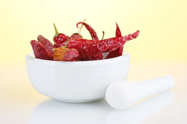 stock image White mortar and pestle with red peppers