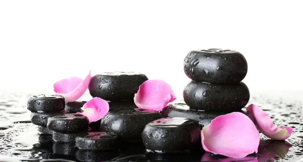 Spa stones with drops and rose petals on white background — Stock Photo, Image