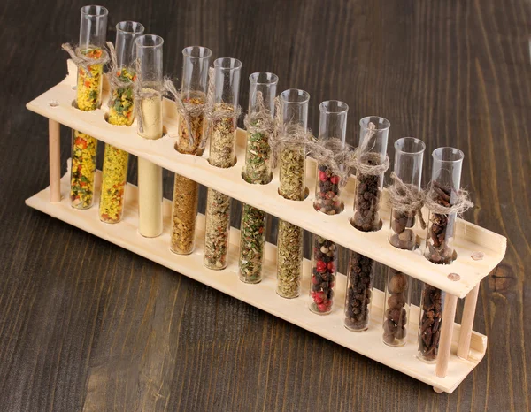 Various spices in tubes on wooden background — Stock Photo, Image