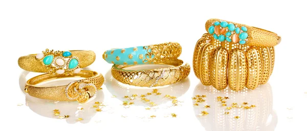 Элегантные и модные золотые браслеты на белом фоне — стоковое фото