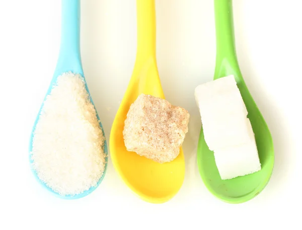 Bright colorful spoons with different types of sugar on white background close-up — Stock Photo, Image
