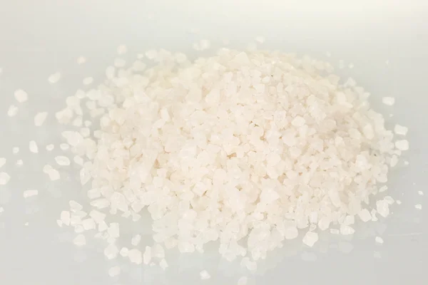 Много морской соли, выделенной на белом — стоковое фото