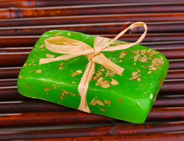 Hand-made herbal soap on bamboo mat — Stock Photo, Image