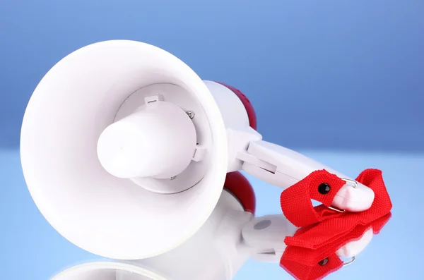 Red and white megaphone on blue background — Stock Photo, Image