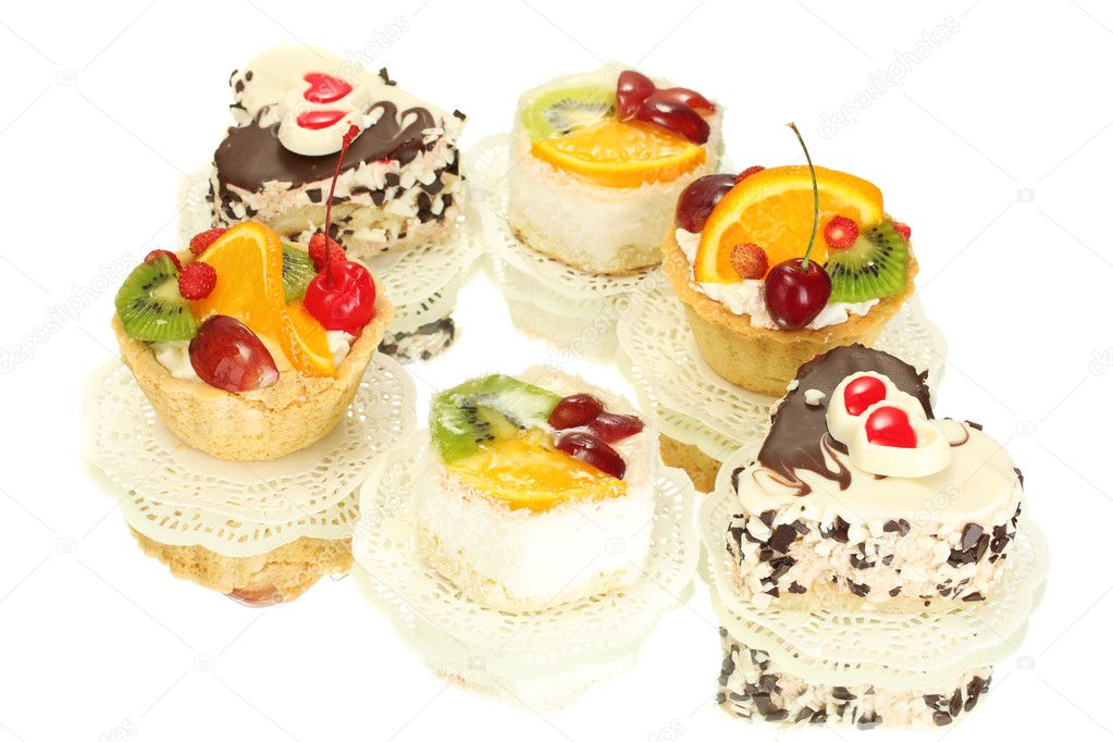Sweet cakes with fruits and chocolate isolated on white