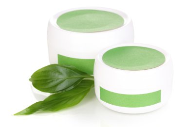 Jars of cream with green leaves isolated on white clipart