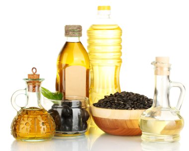 Olive and sunflower oil in the bottles and small decanters isolated on white clipart