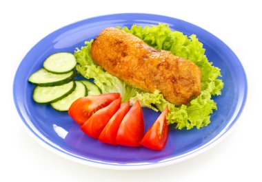 Tasty meat cutlet with garnish on plate isolated on white