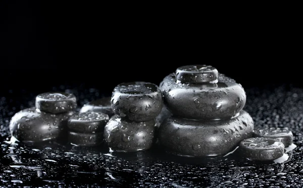 Spa stones with drops on black background — Stock Photo, Image