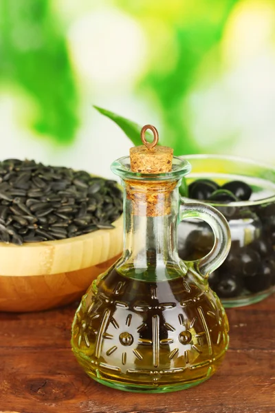 Olive oil small decanter on green background close-up — Stock Photo, Image