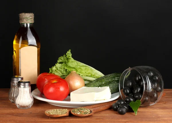 Ingredients for a Greek salad on black background — Stock Photo, Image
