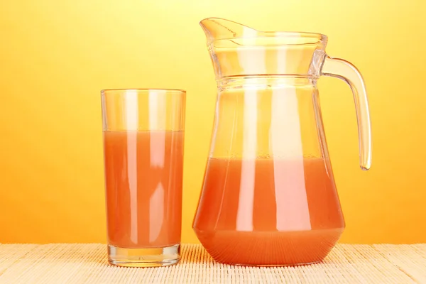 葡萄柚汁和葡萄柚竹垫在黄色背景上 — 图库照片