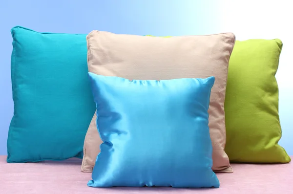 Bright pillows on blue background — Stock Photo, Image