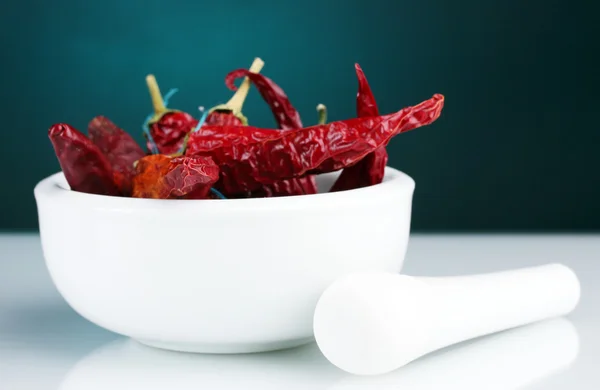 stock image White mortar and pestle with red peppers