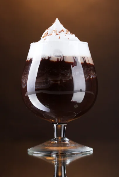 stock image Glass of coffee cocktail on brown background