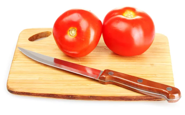 Ripe red tomatoes and knife on cutting board isolated on white — Stock Photo, Image