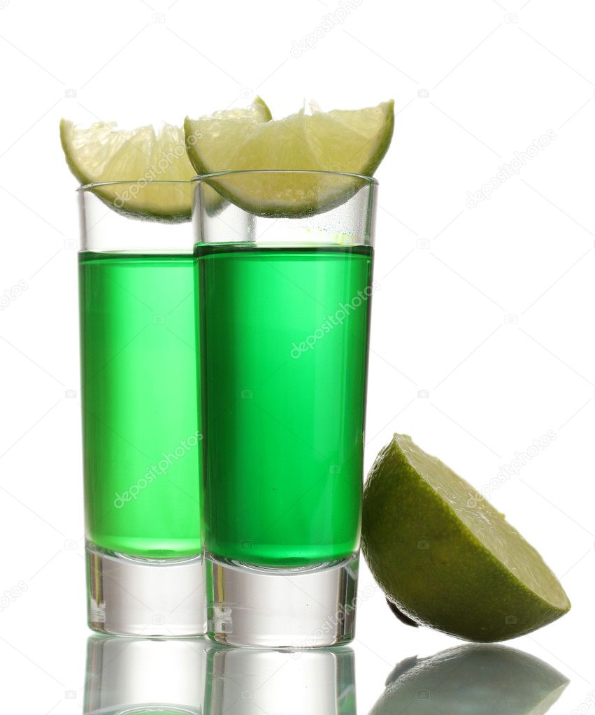 Glasses of absinthe and lime isolated on white