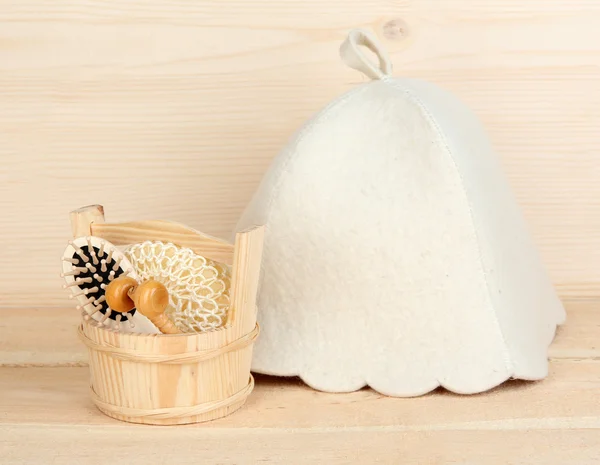Sauna hat bathroom set on wooden background — Stock Photo, Image