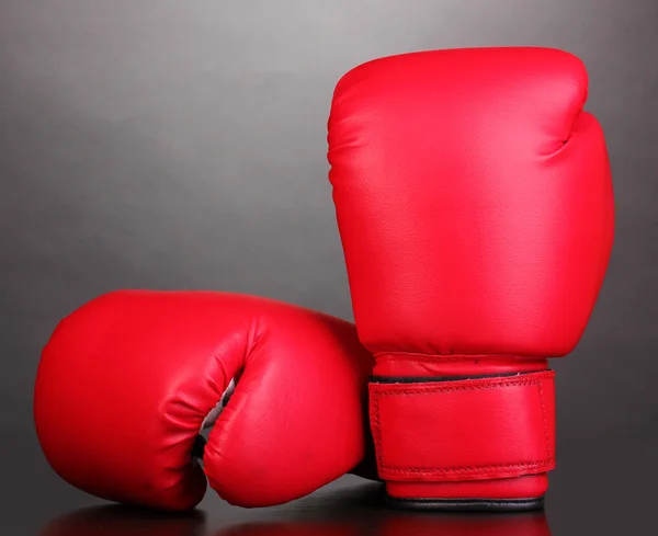 Red boxing gloves on grey background — Stock Photo, Image