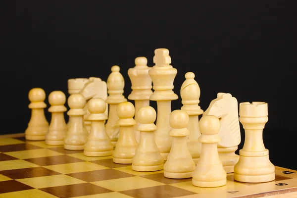 Chess board with chess pieces isolated on black — Stock Photo, Image
