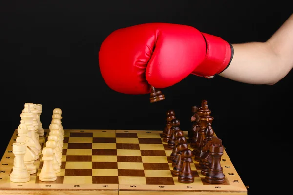 Playing chess in boxing gloves isolated on black — Stock Photo, Image