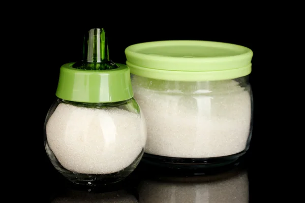 Sugar bowl and jar with crystal sugar isolated on black background close-up — Stock Photo, Image