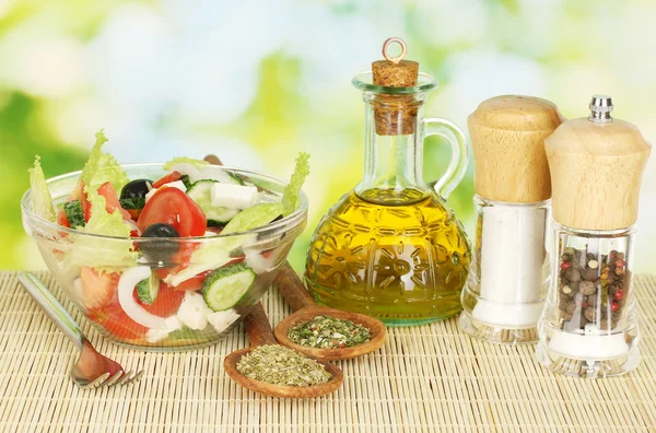 Tasty greek salad on bright green background — Stock Photo, Image