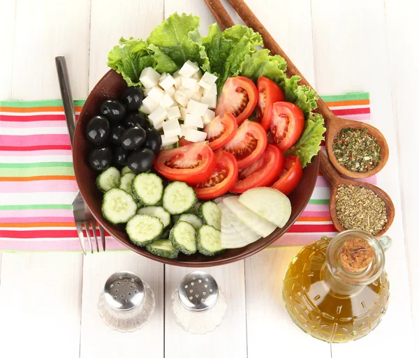 Tasty Greek salad with spices on white wooden background — Stock Photo, Image