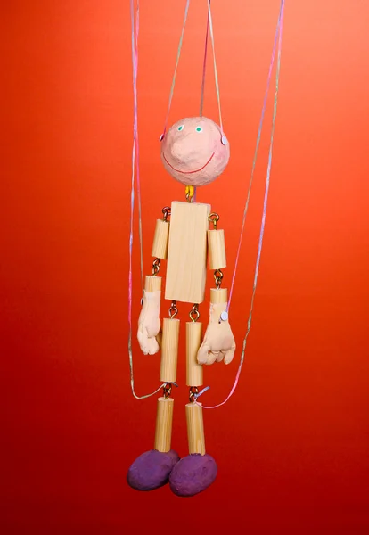 Houten marionet op rode achtergrond — Stockfoto
