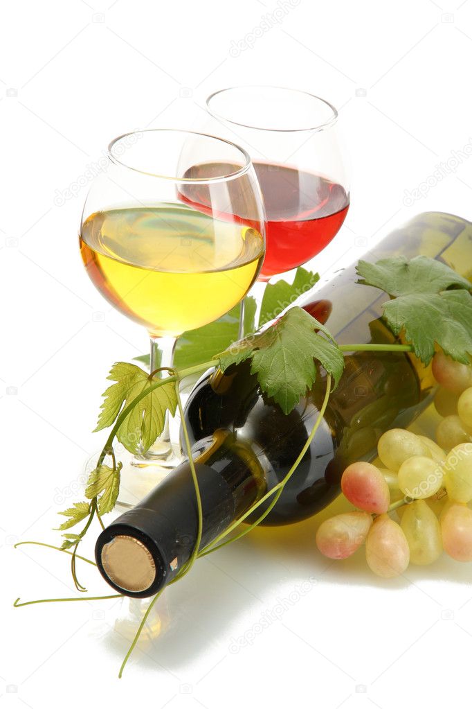 Bottle and glasses of wine and ripe grapes isolated on white