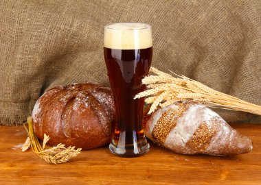 Glass of kvass with bread on canvas background close-up clipart